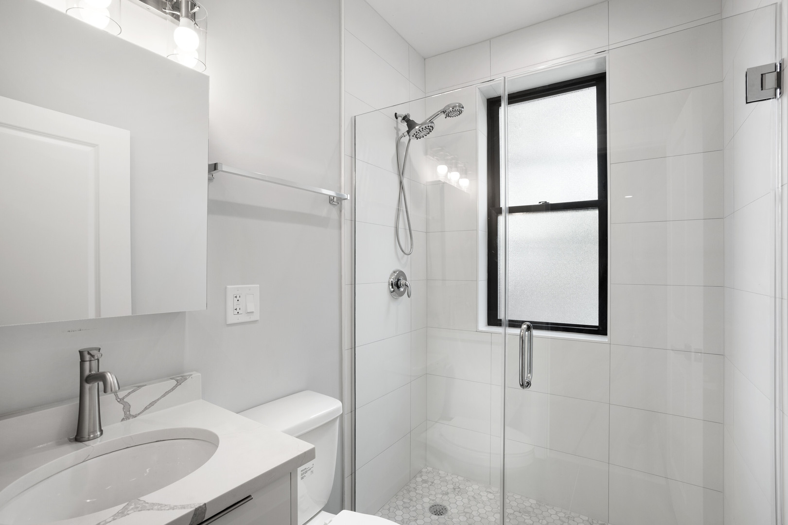 1552 West Juneway Terrace, Unit 3E Chicago, IL 60626 - Photo 12 of 13 a bathroom with a shower sink and mirror