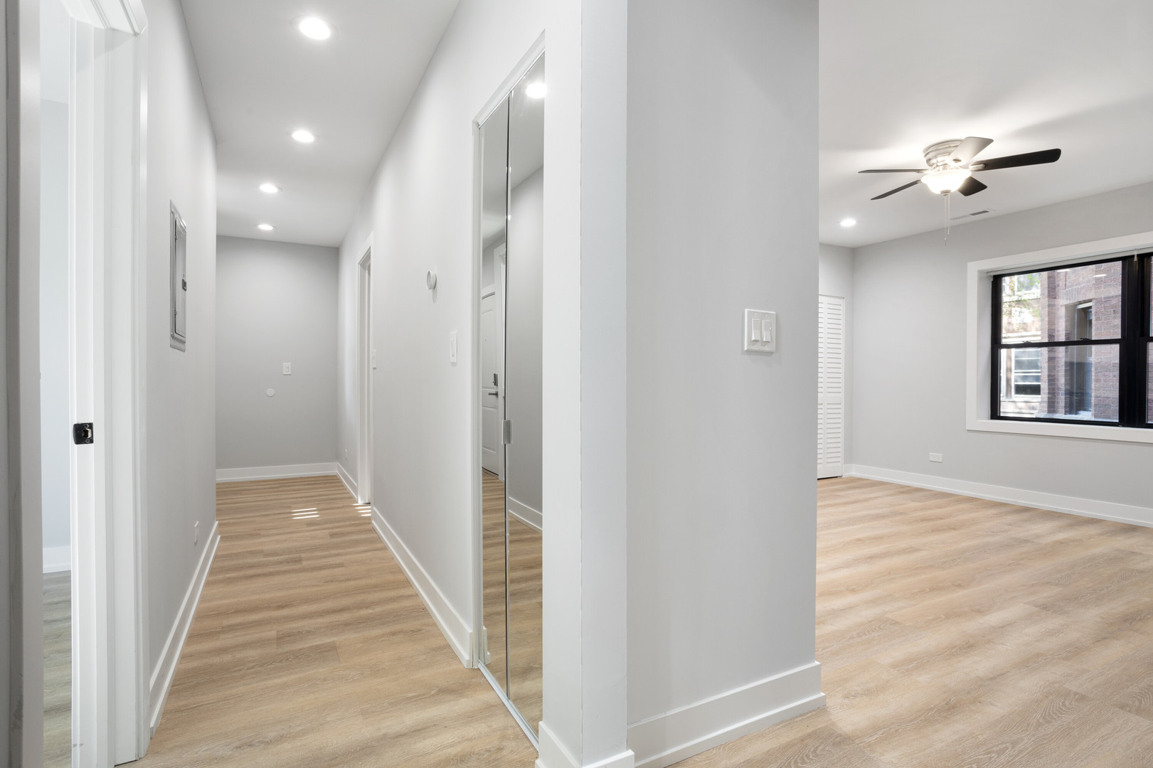 1552 West Juneway Terrace, Unit 3E Chicago, IL 60626 - Photo 6 of 13 a view of a hallway with wooden floor and chandelier