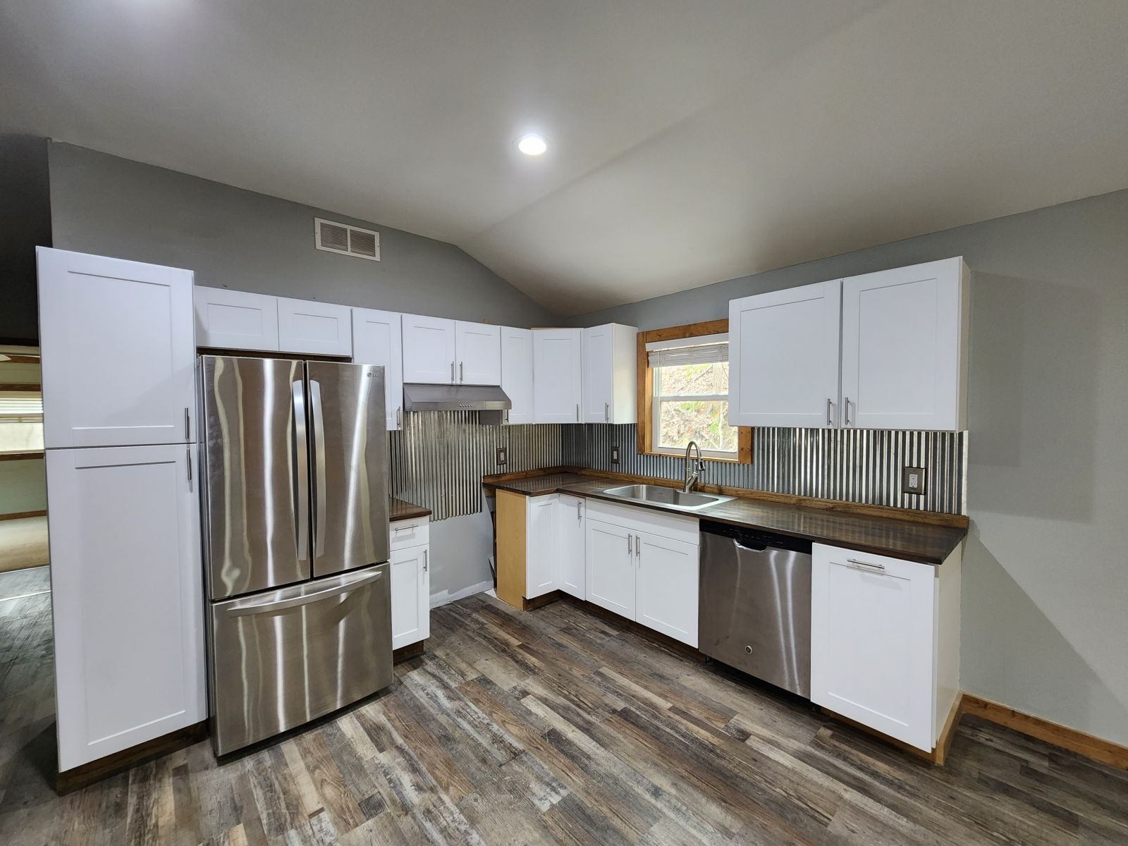 2179 Hackney Road Greenbrier, TN 37073 - Photo 6 of 20 a kitchen with stainless steel appliances a refrigerator a sink and white cabinets