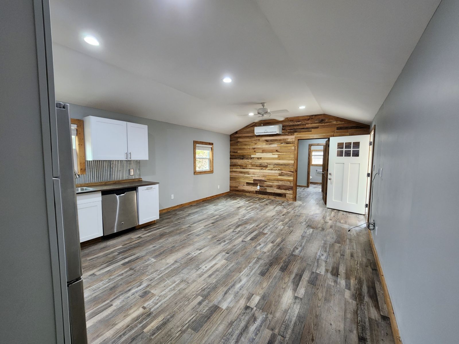 2179 Hackney Road Greenbrier, TN 37073 - Photo 8 of 20 a view of empty room with a kitchen and wooden floor
