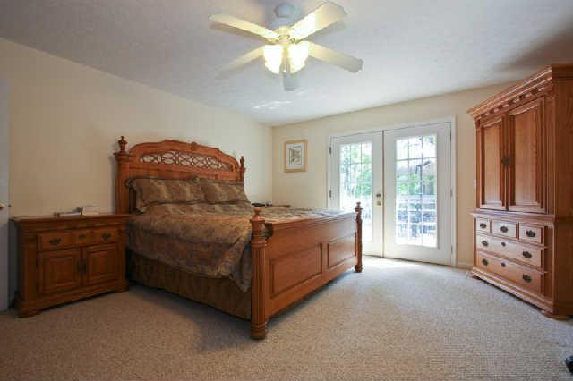 7584 Crow Cut Road Fairview, TN 37062 - Photo 13 of 20 Restful and private master suite on the main level. French doors to wooden deck on back of house. You will want to 'sleep in' on those weekend mornings...