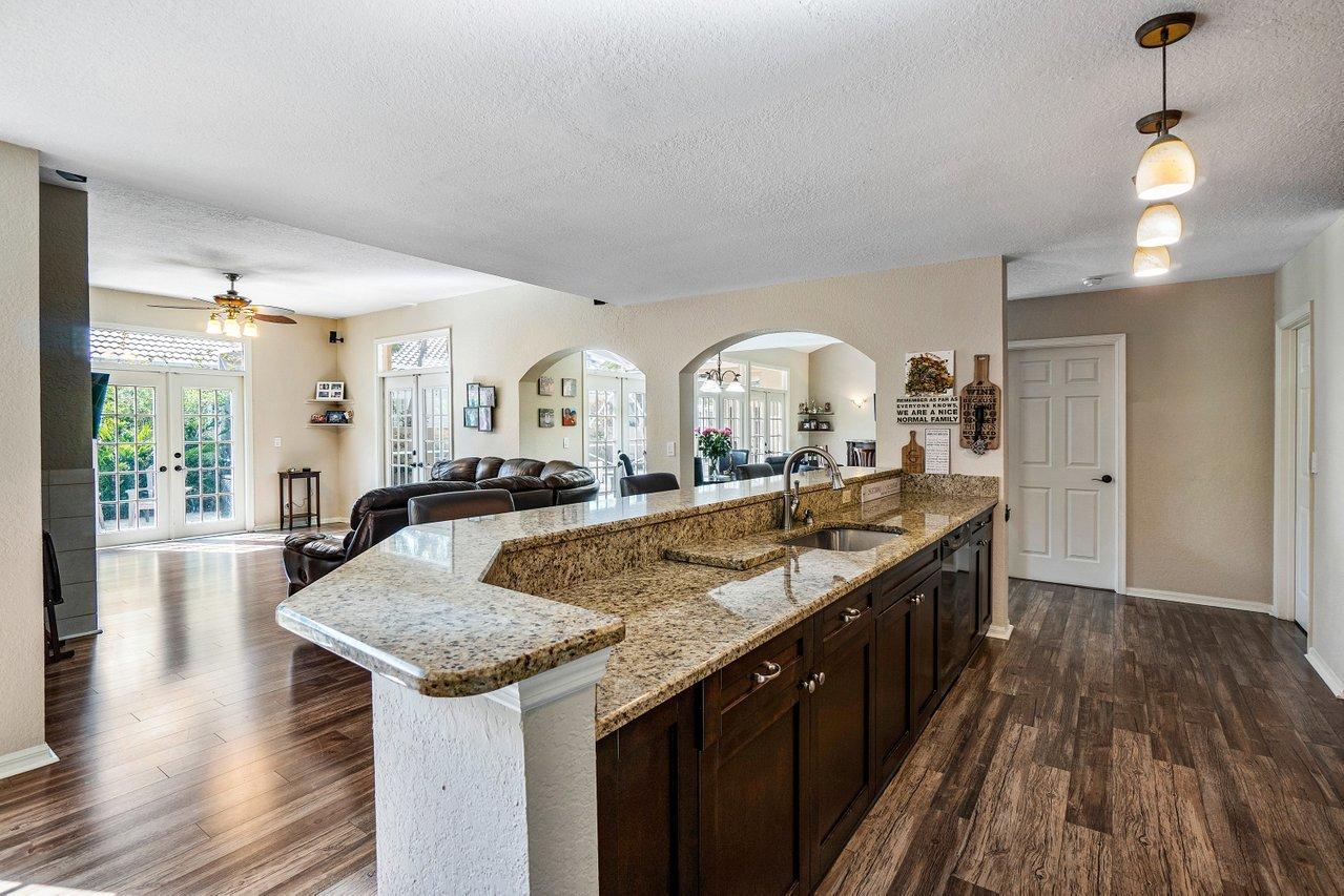 10921 Haydn Drive Boca Raton, FL 33498 - Photo 11 of 45 a living room with granite countertop kitchen island with wooden floors