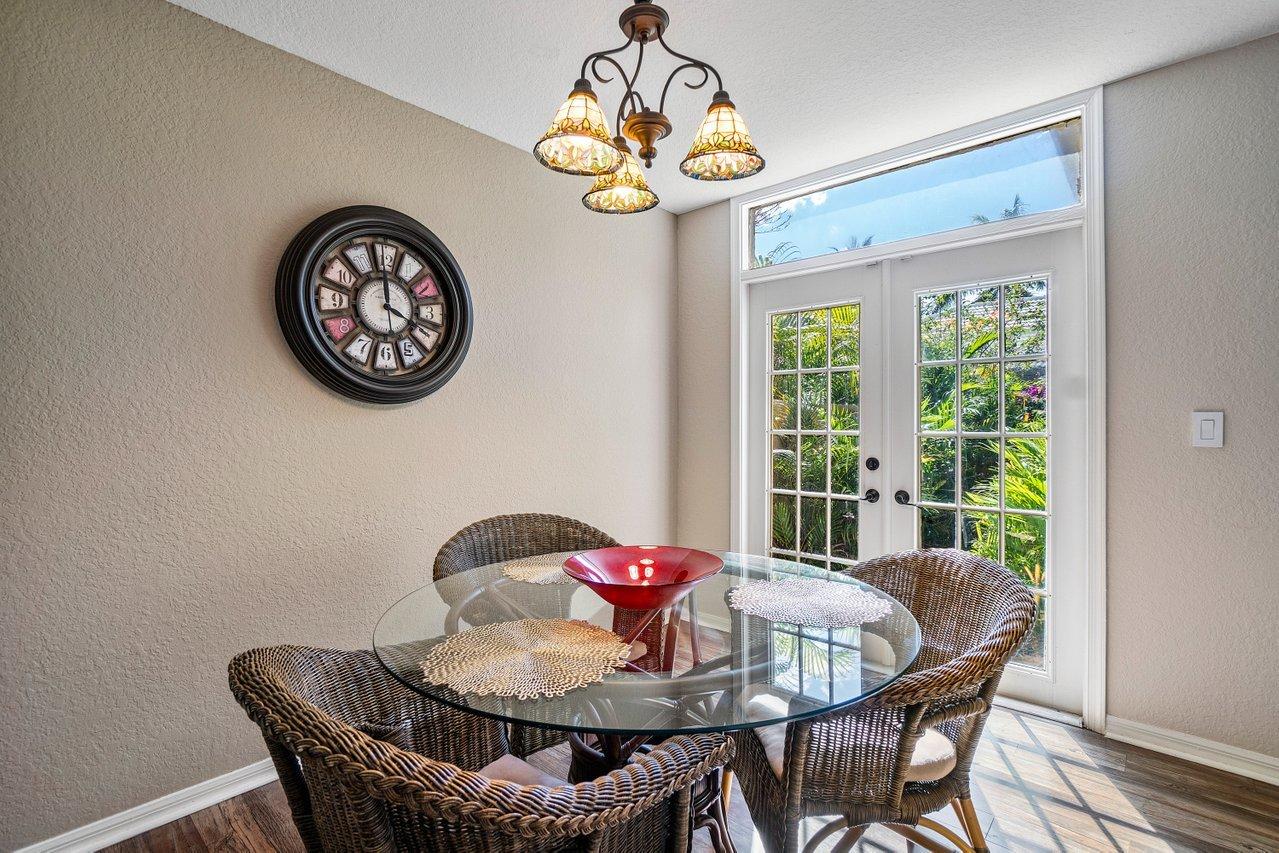 10921 Haydn Drive Boca Raton, FL 33498 - Photo 13 of 45 a view of a dining room with furniture chandelier and a window
