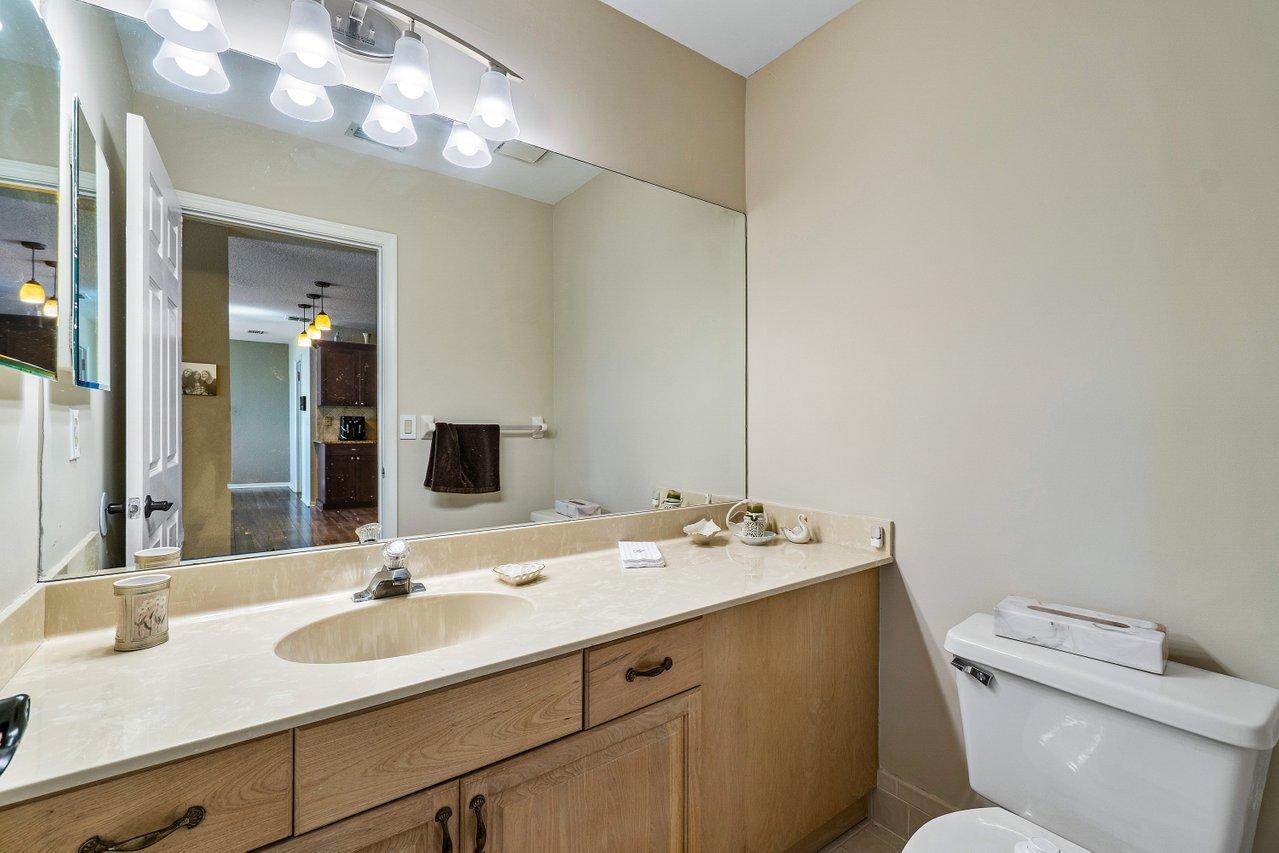 10921 Haydn Drive Boca Raton, FL 33498 - Photo 14 of 45 a bathroom with a sink a toilet and mirror