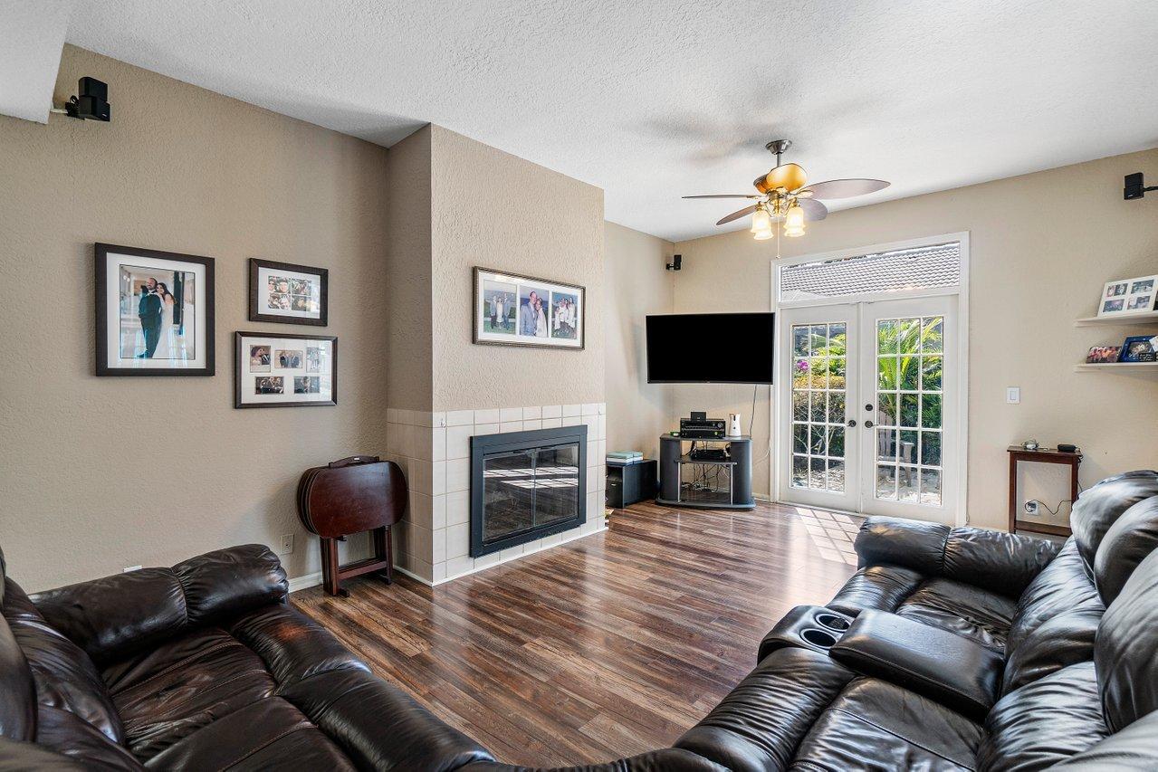 10921 Haydn Drive Boca Raton, FL 33498 - Photo 15 of 45 a living room with furniture a fireplace and a flat screen tv