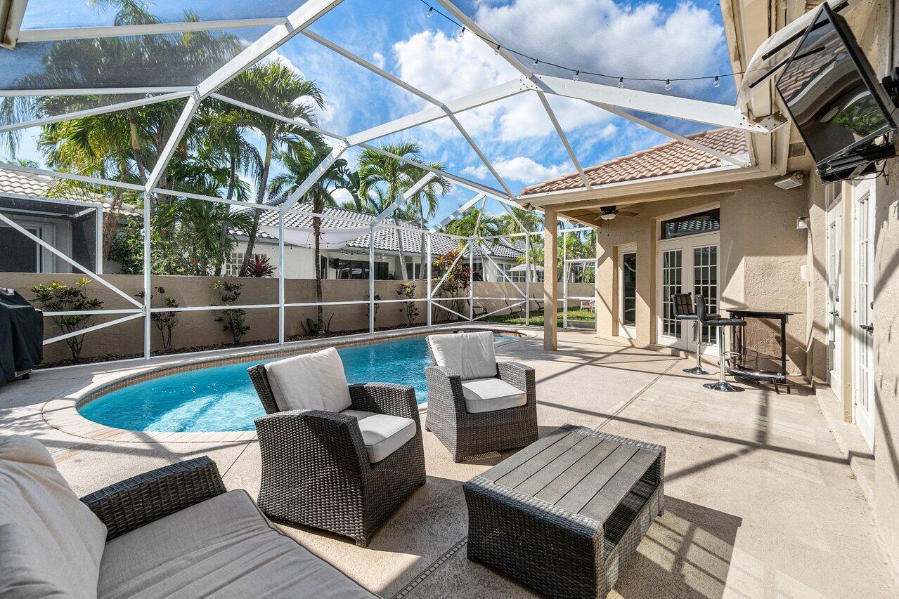 10921 Haydn Drive Boca Raton, FL 33498 - Photo 18 of 45 a view of a patio with couches chairs and wooden floor