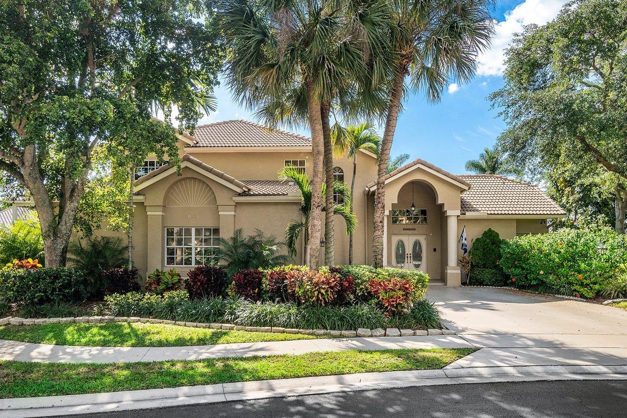 10921 Haydn Drive Boca Raton, FL 33498 - Photo 2 of 45 a front view of a house with a yard and potted plants