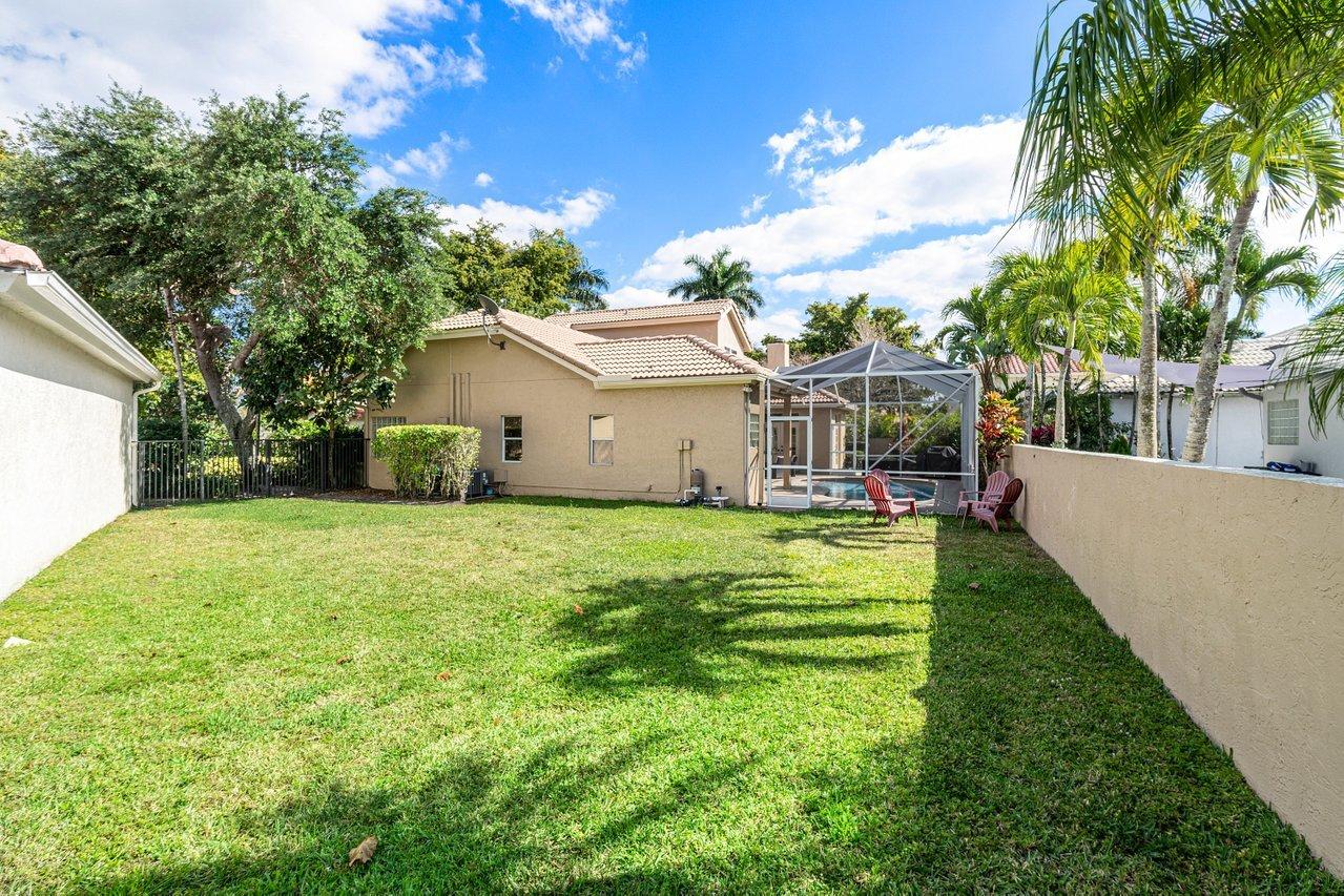 10921 Haydn Drive Boca Raton, FL 33498 - Photo 21 of 45 a view of a house with backyard and a tree