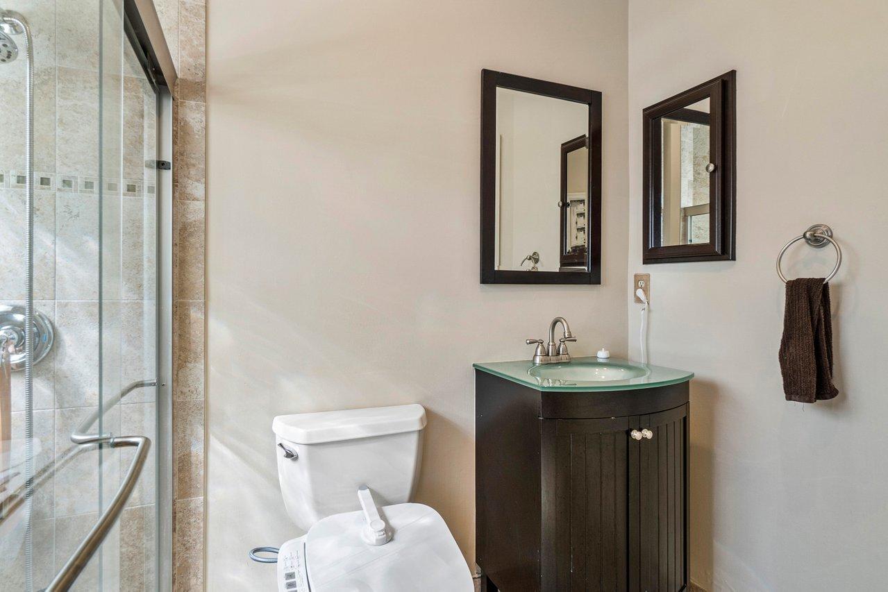 10921 Haydn Drive Boca Raton, FL 33498 - Photo 26 of 45 a bathroom with a toilet sink and mirror