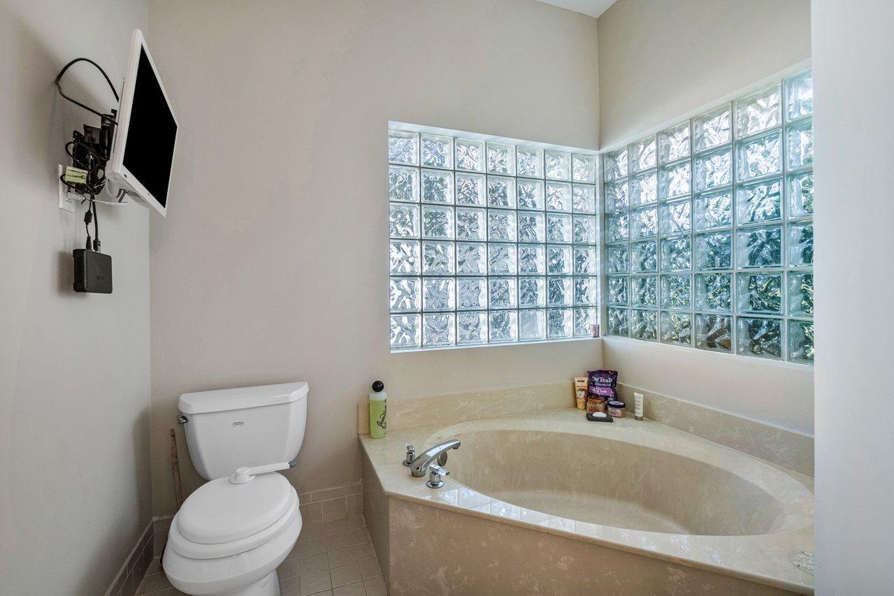 10921 Haydn Drive Boca Raton, FL 33498 - Photo 27 of 45 a white bath tub sitting next to a toilet
