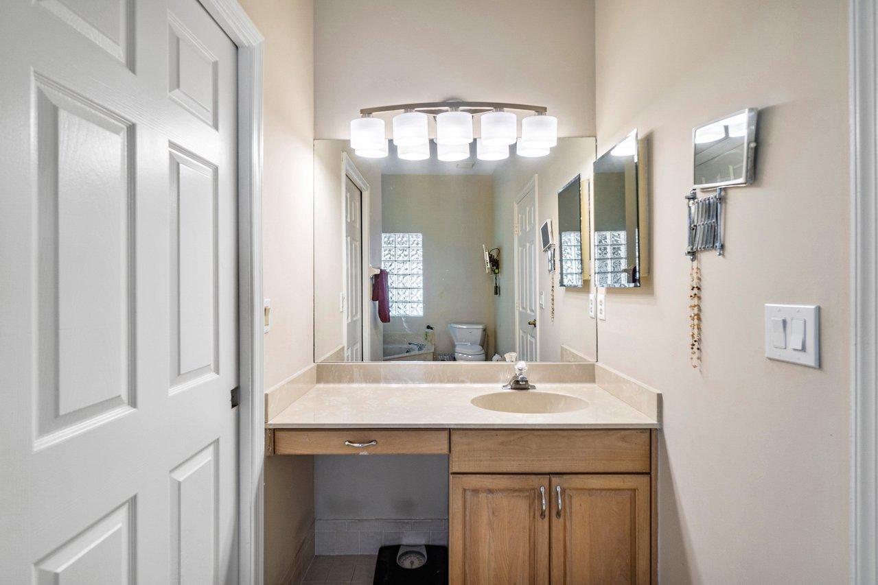 10921 Haydn Drive Boca Raton, FL 33498 - Photo 28 of 45 a bathroom with a sink and a mirror