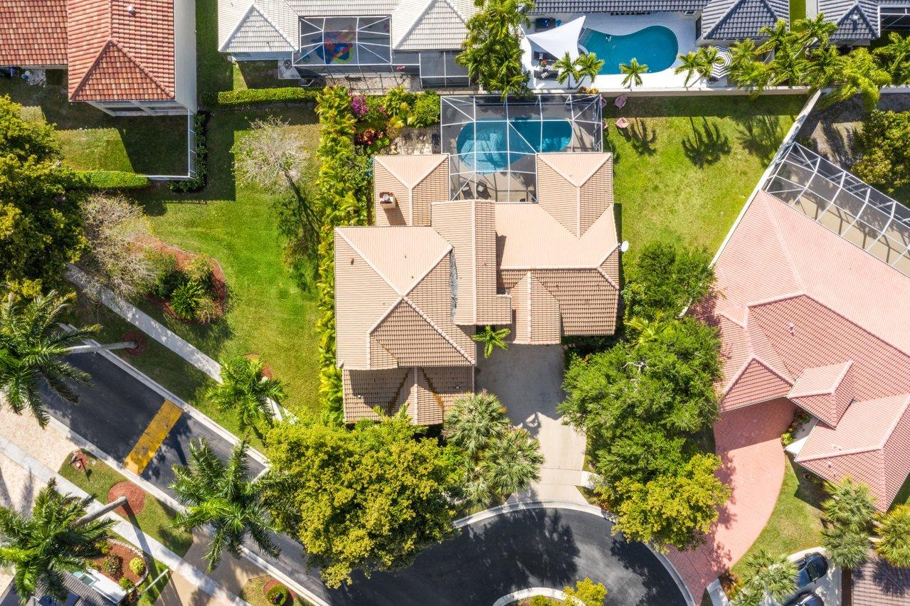 10921 Haydn Drive Boca Raton, FL 33498 - Photo 3 of 45 an aerial view of a house with a garden and lake view
