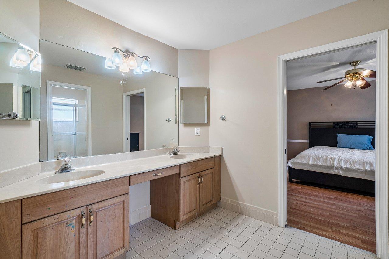 10921 Haydn Drive Boca Raton, FL 33498 - Photo 32 of 45 a spacious bathroom with a double vanity sink and a mirror