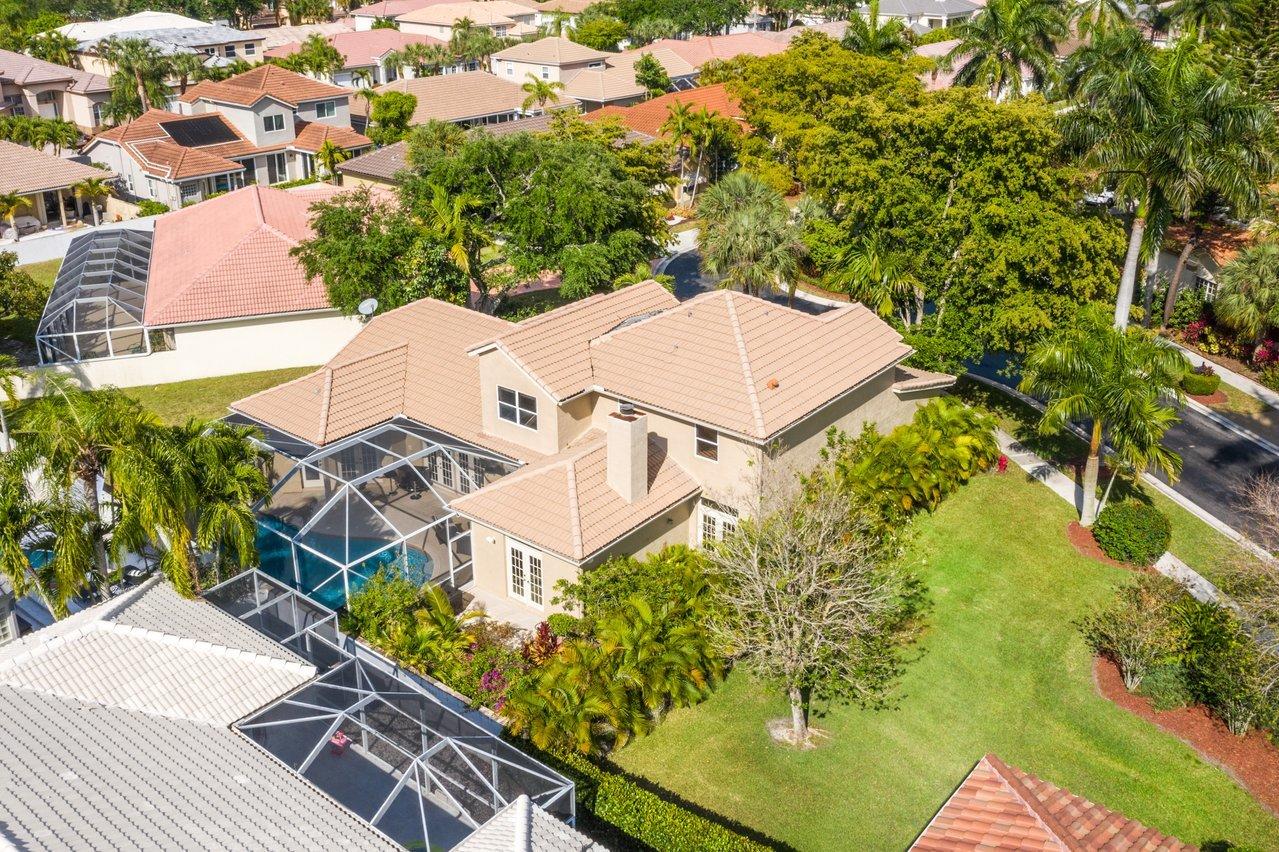 10921 Haydn Drive Boca Raton, FL 33498 - Photo 40 of 45 an aerial view of a house with garden space and trees
