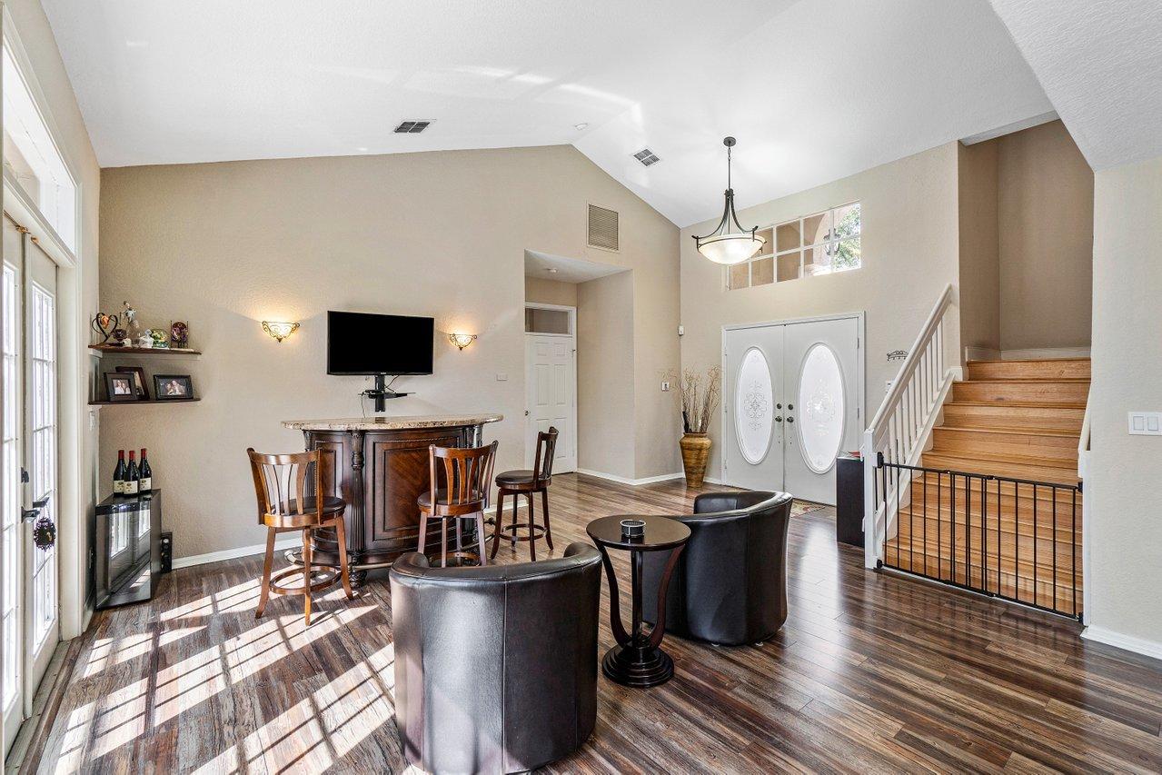 10921 Haydn Drive Boca Raton, FL 33498 - Photo 8 of 45 a living room with furniture a flat screen tv and kitchen view