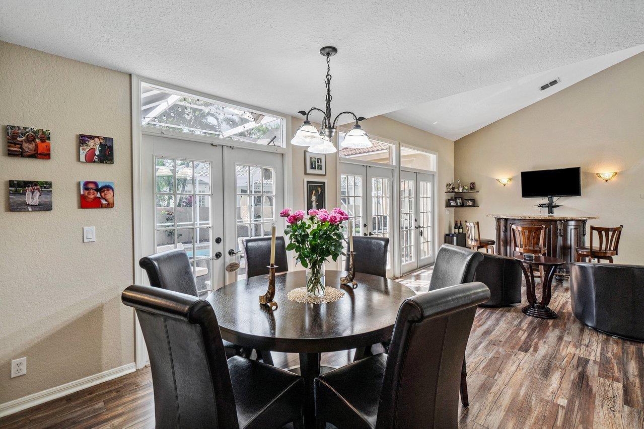 10921 Haydn Drive Boca Raton, FL 33498 - Photo 9 of 45 a view of a dining room with furniture and a chandelier