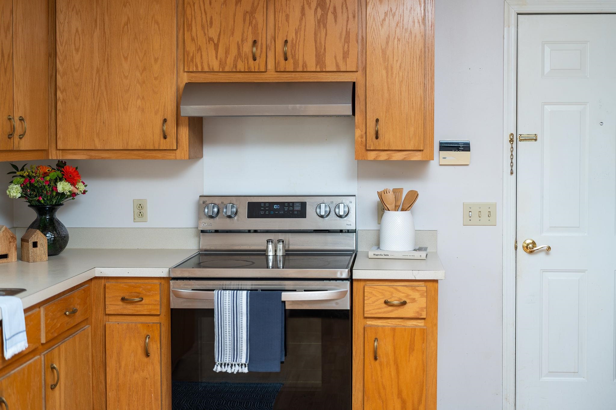 479 Battlefield Road Fort Defiance, VA 24437 - Photo 15 of 51 a kitchen with stainless steel appliances granite countertop a stove a microwave and cabinets