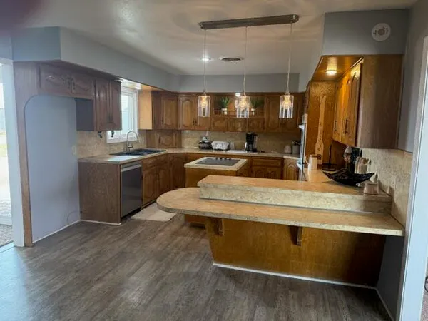 a kitchen with a sink cabinets and window