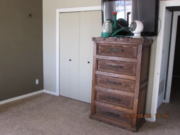 a bedroom with a bed and a couch