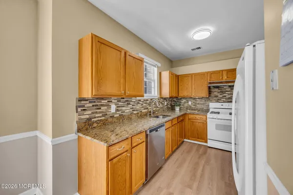 a spacious bedroom with a bed and a chandelier