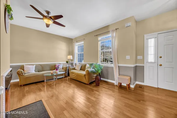 a living room with furniture and a wooden floor