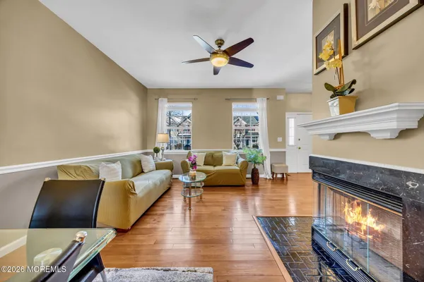 a living room with furniture and wooden floor