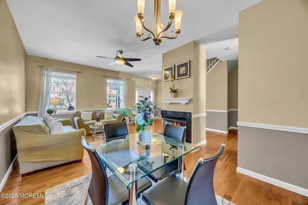 a dining room with furniture a fireplace and chandelier