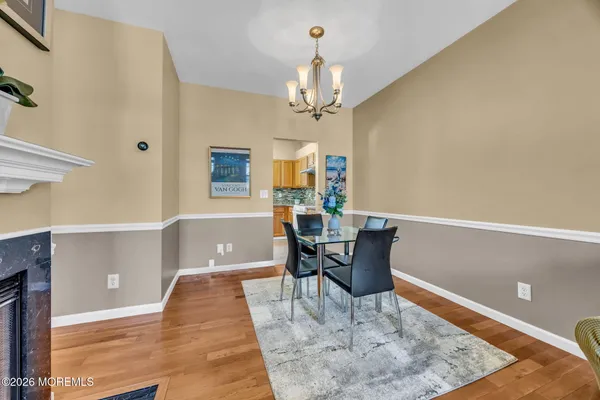 a kitchen with stainless steel appliances granite countertop a sink and cabinets with wooden floor