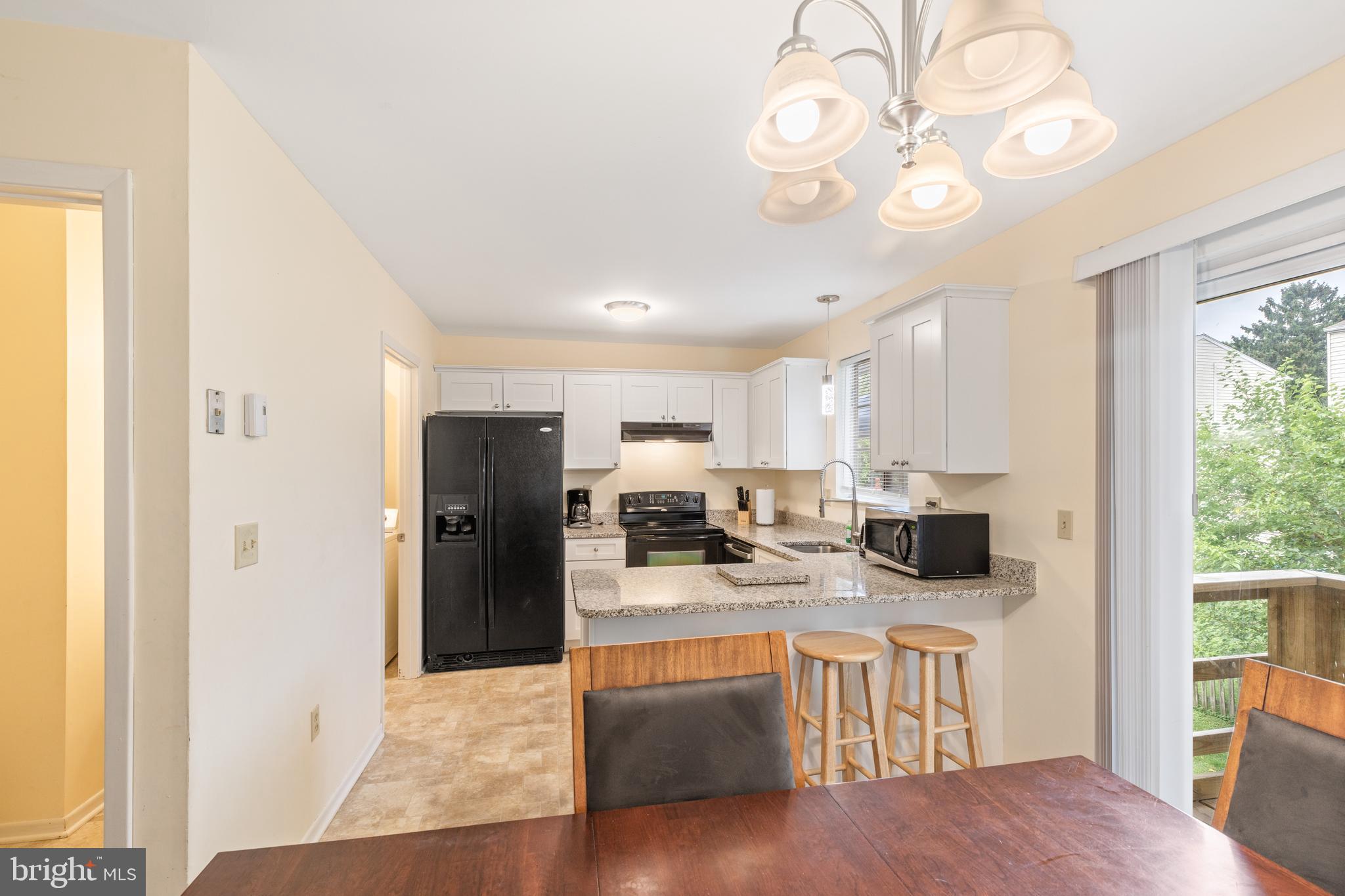276 Broad Street Highspire, PA 17034 - Photo 6 of 28 a kitchen with stainless steel appliances granite countertop a sink a stove cabinets and wooden floor