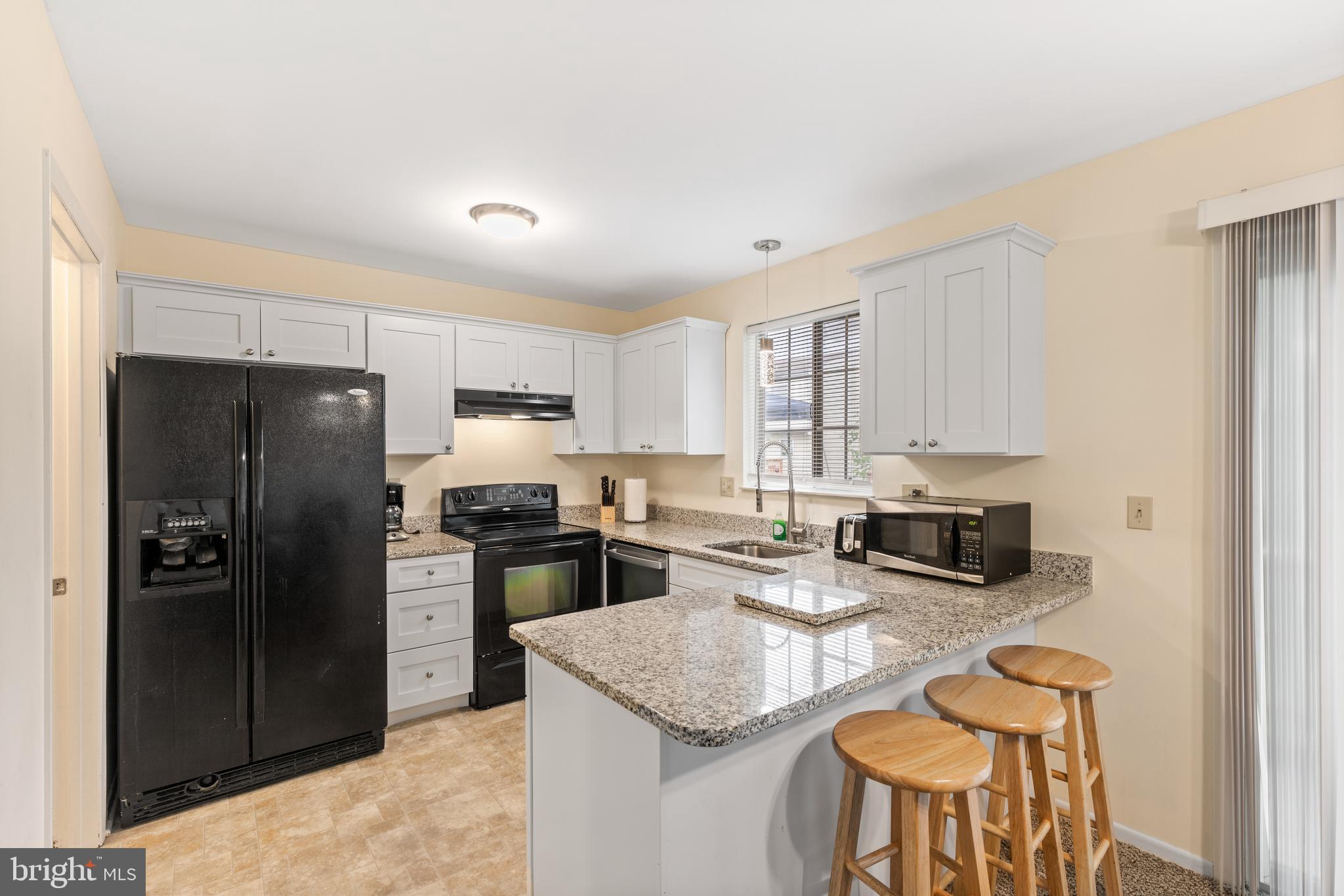 276 Broad Street Highspire, PA 17034 - Photo 7 of 28 a kitchen with stainless steel appliances granite countertop a refrigerator stove microwave and sink
