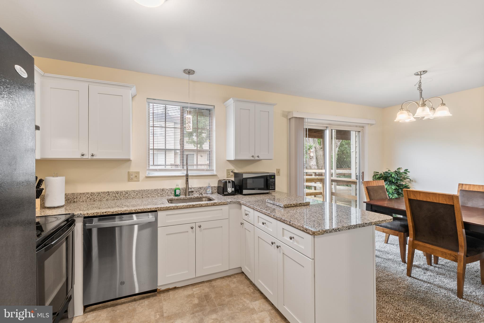 276 Broad Street Highspire, PA 17034 - Photo 8 of 28 a kitchen with granite countertop white cabinets and white appliances