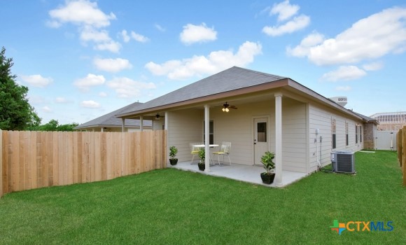a view of an house with backyard space and garden