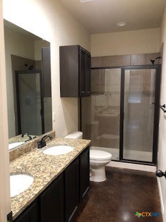 1509 Lucille Street Seguin, TX 78155 - Photo 10 of 11 a bathroom with a granite countertop sink toilet and shower
