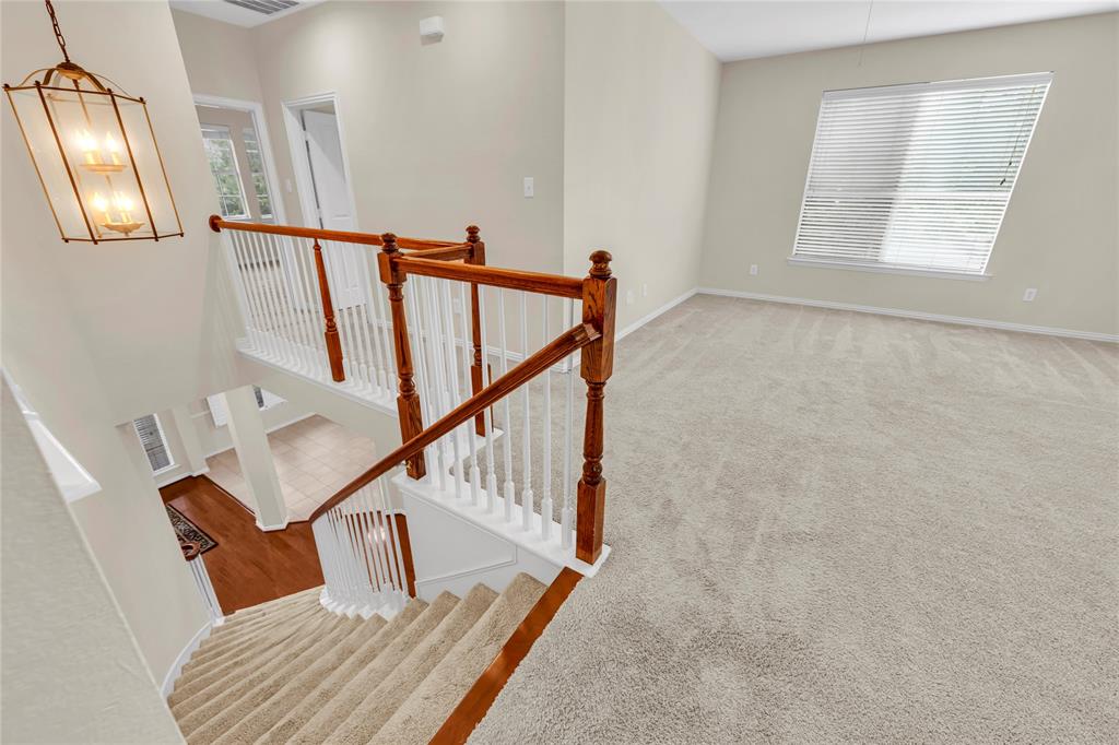 3920 Autumn Lane Bedford, TX 76021 - Photo 24 of 36 Upper-level landing with plush carpeting and natural light from a large window