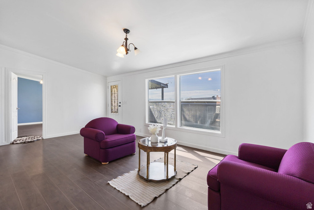 2600 North Hill Field Road, Unit 86 Layton, UT 84041 - Photo 2 of 25 Living room featuring wood finished floors, crown molding, and hanging lights