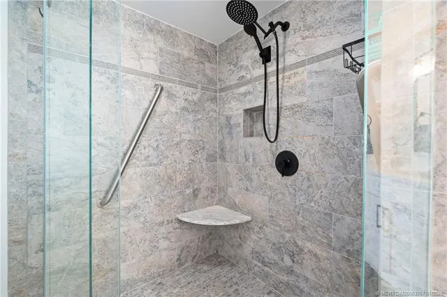 a bathroom with a shower sink and mirror