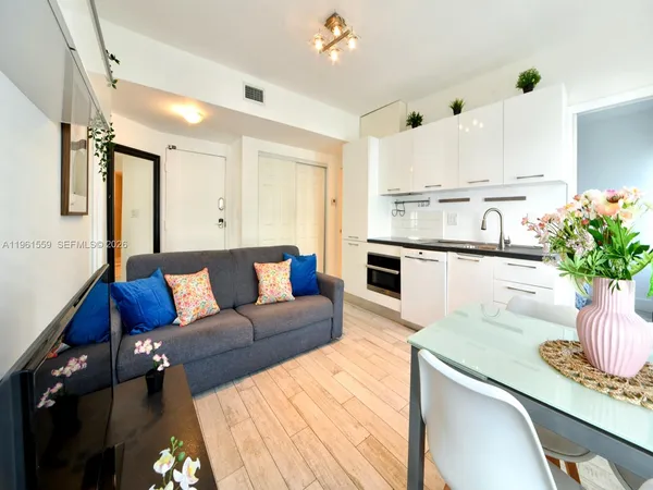 a living room with furniture and a potted plant