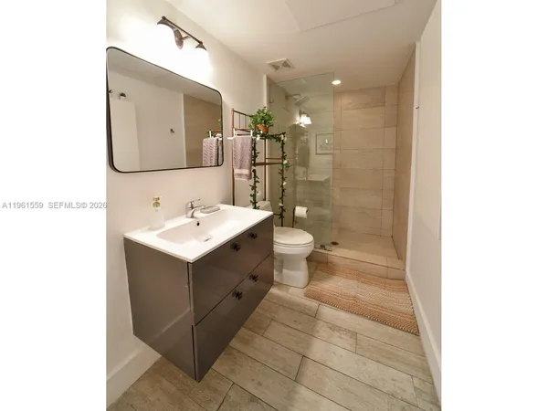 a bathroom with a sink toilet and shower