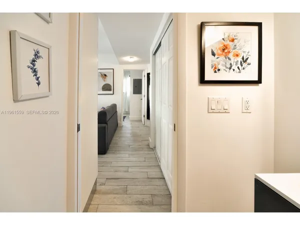a view of a hallway with wooden floor