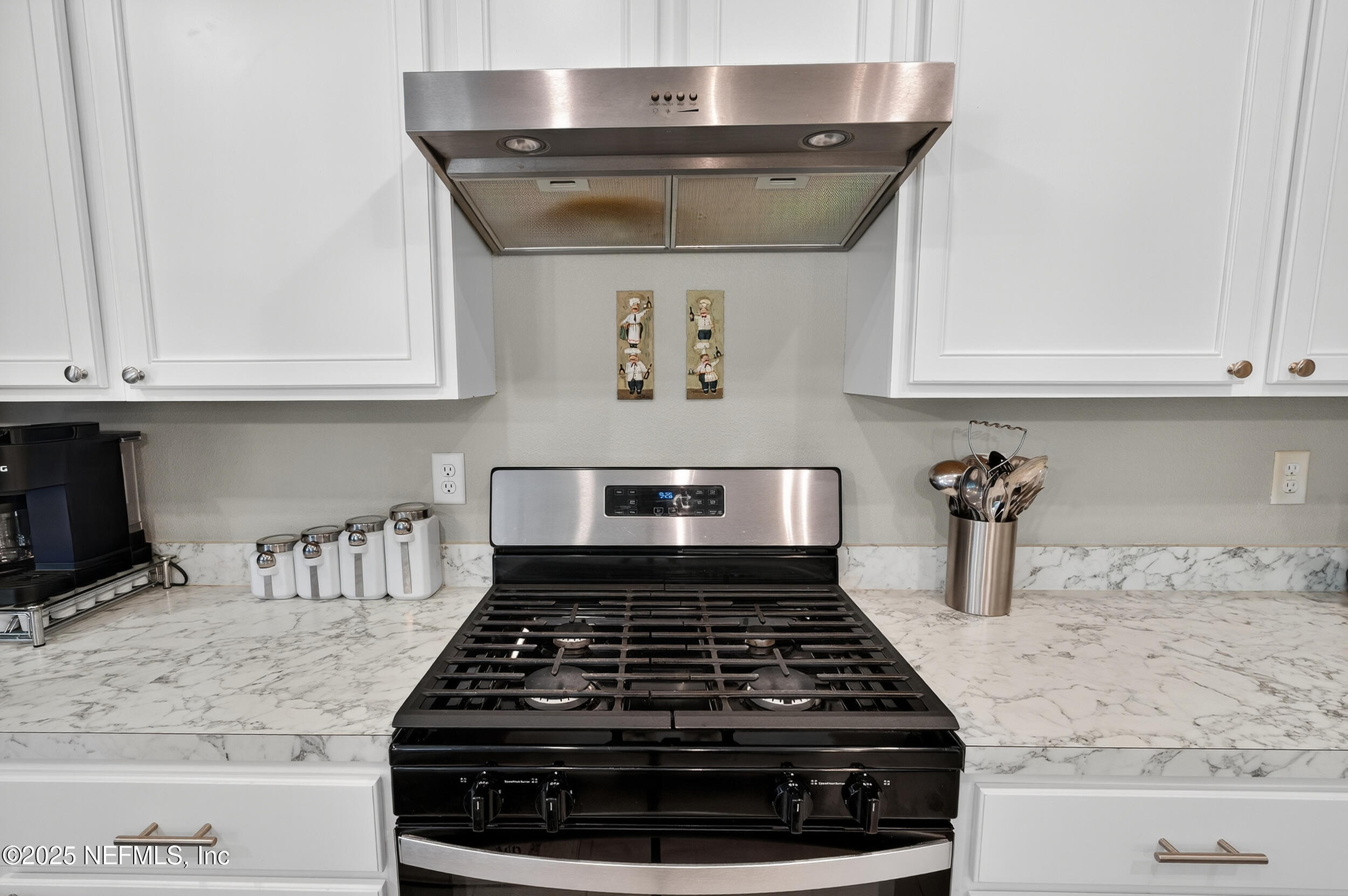 318 Rambling Brk Trail St. Johns, FL 32259 - Photo 11 of 26 a kitchen with granite countertop a stove and white cabinets