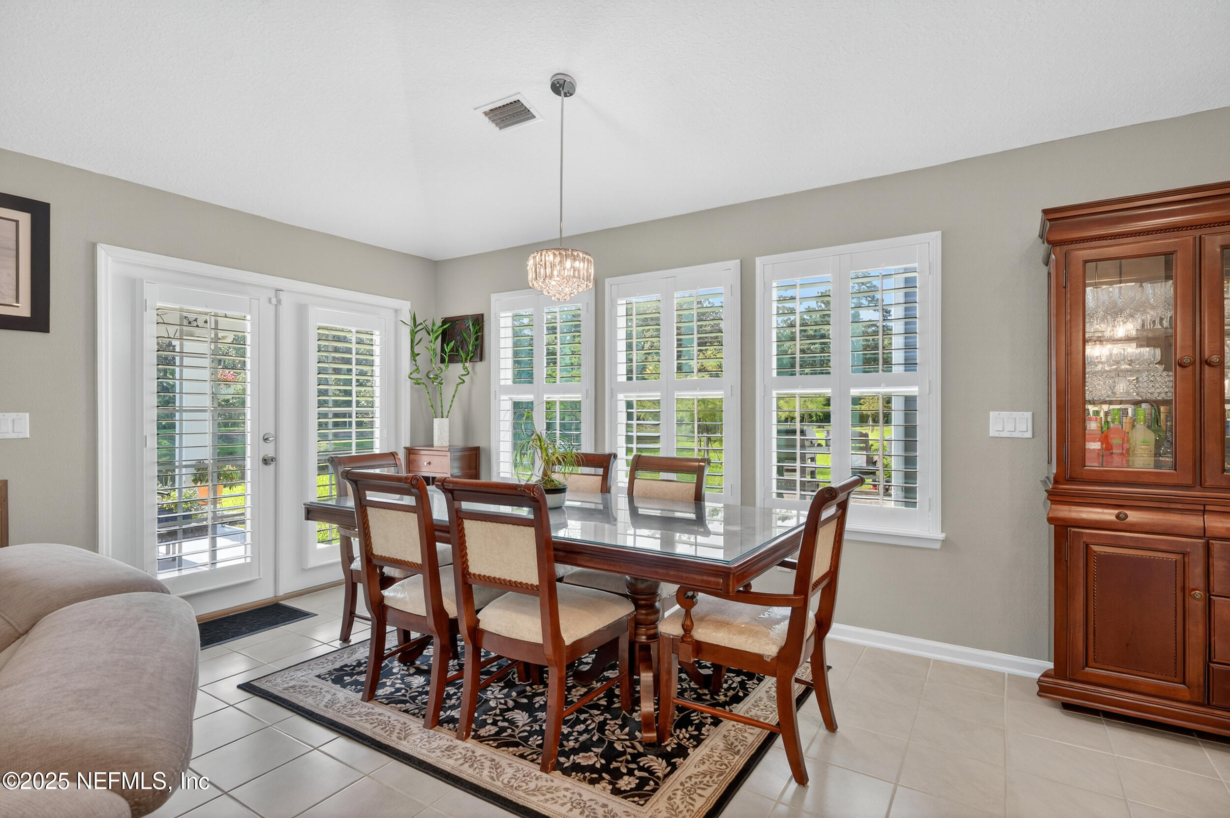 318 Rambling Brk Trail St. Johns, FL 32259 - Photo 13 of 26 a view of a dining room with furniture large windows and wooden floor
