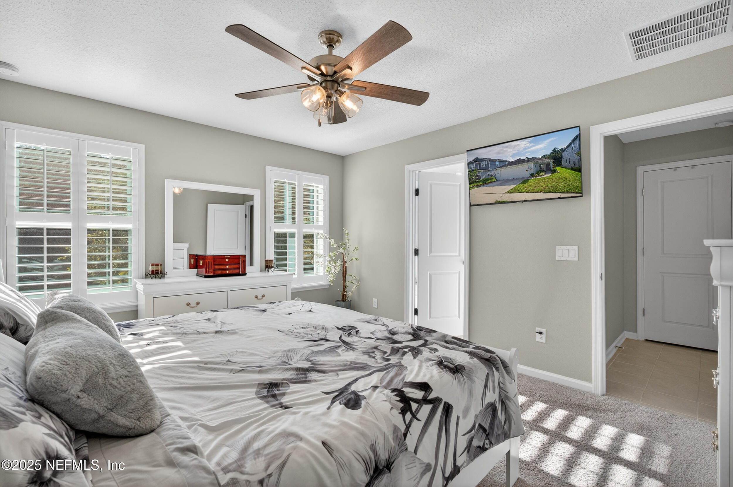 318 Rambling Brk Trail St. Johns, FL 32259 - Photo 16 of 26 a bedroom with a bed and a chandelier