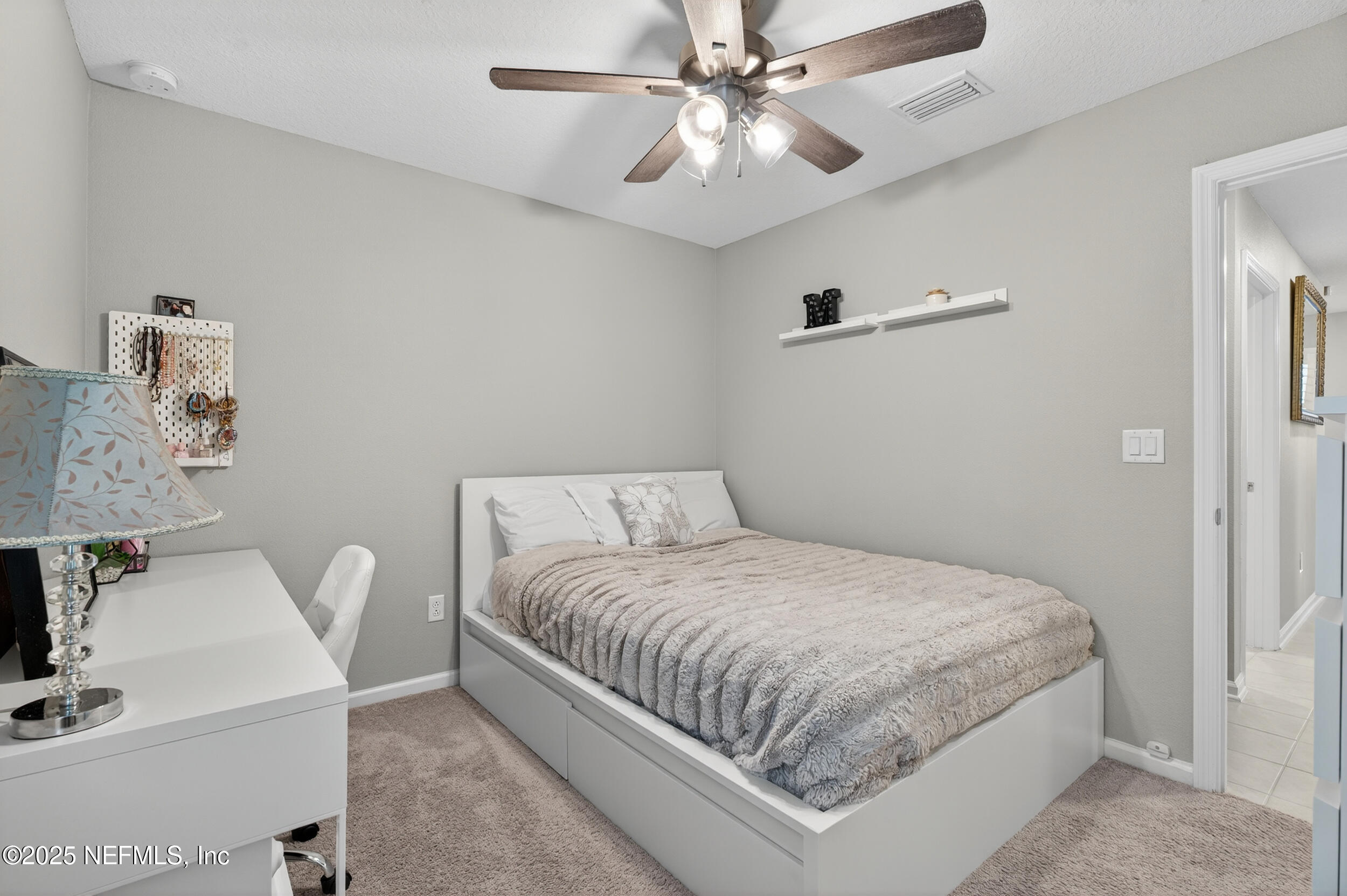 318 Rambling Brk Trail St. Johns, FL 32259 - Photo 22 of 26 a bedroom with a large bed and a chandelier