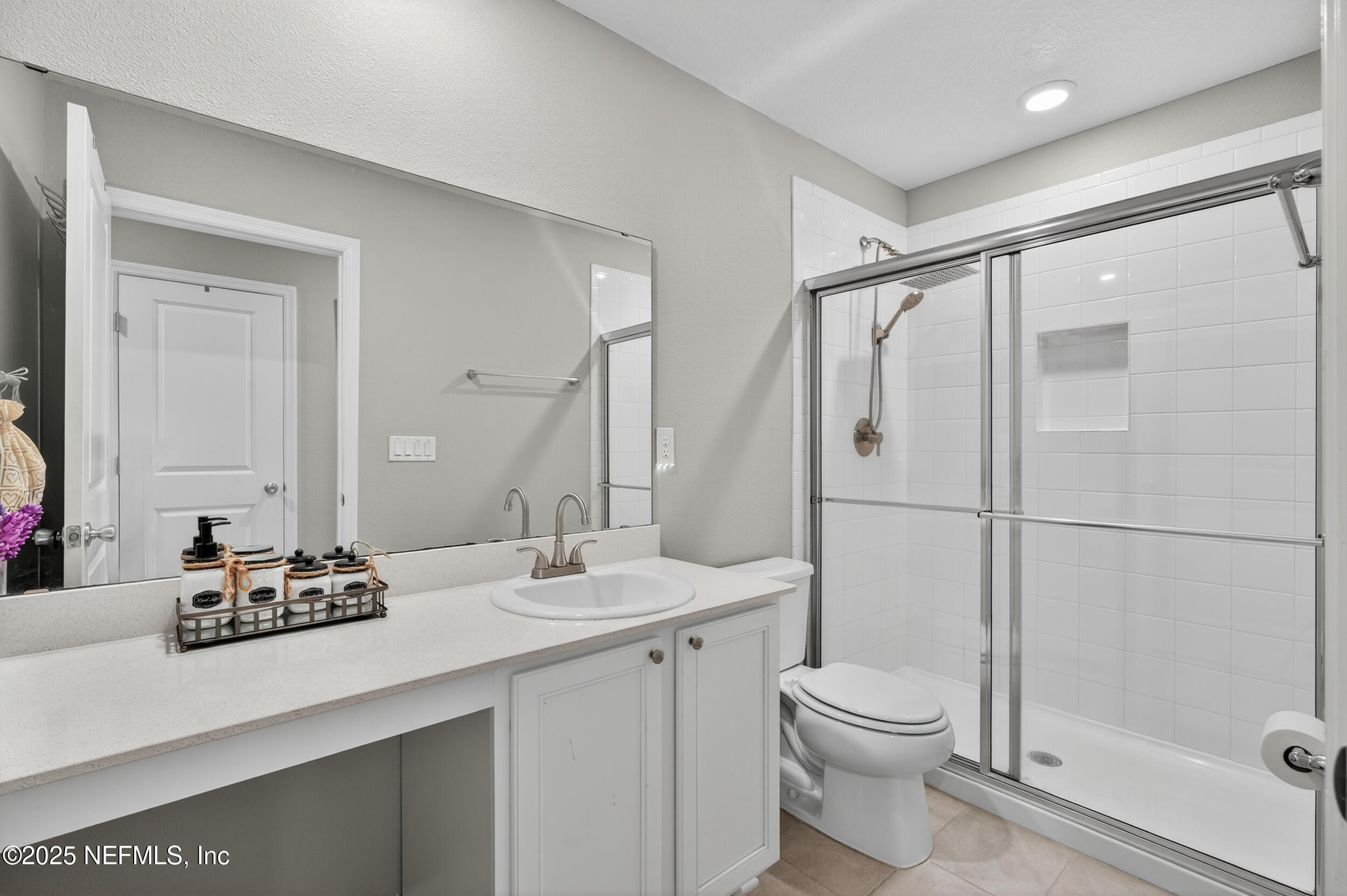 318 Rambling Brk Trail St. Johns, FL 32259 - Photo 23 of 26 a bathroom with a double vanity sink toilet and shower