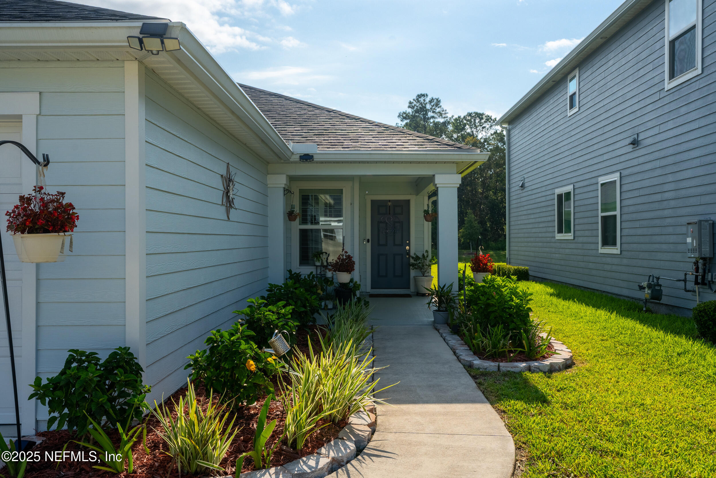 318 Rambling Brk Trail St. Johns, FL 32259 - Photo 5 of 26 a view of a house with potted plants next to a yard