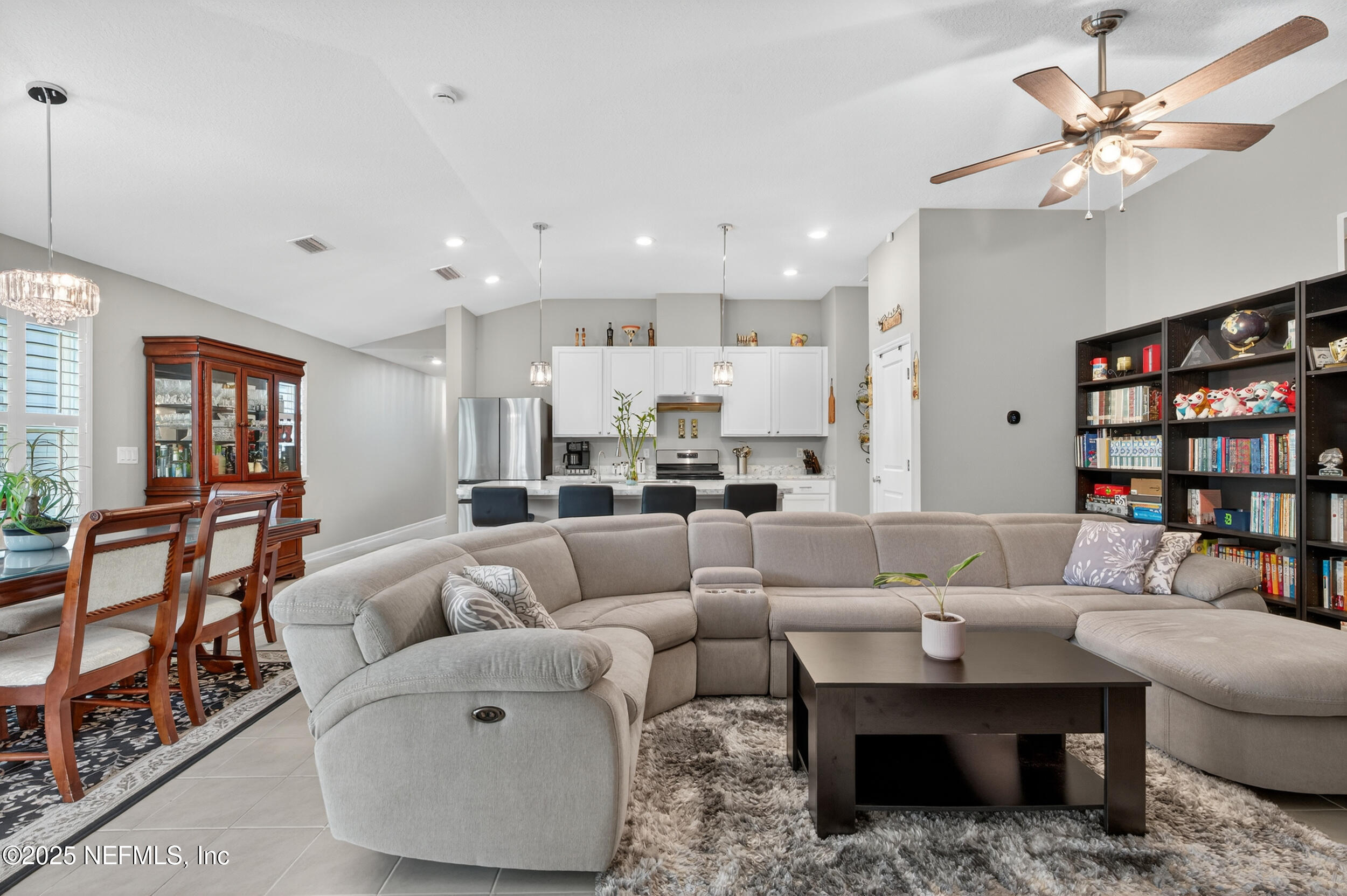 318 Rambling Brk Trail St. Johns, FL 32259 - Photo 8 of 26 a living room with furniture and a book shelf