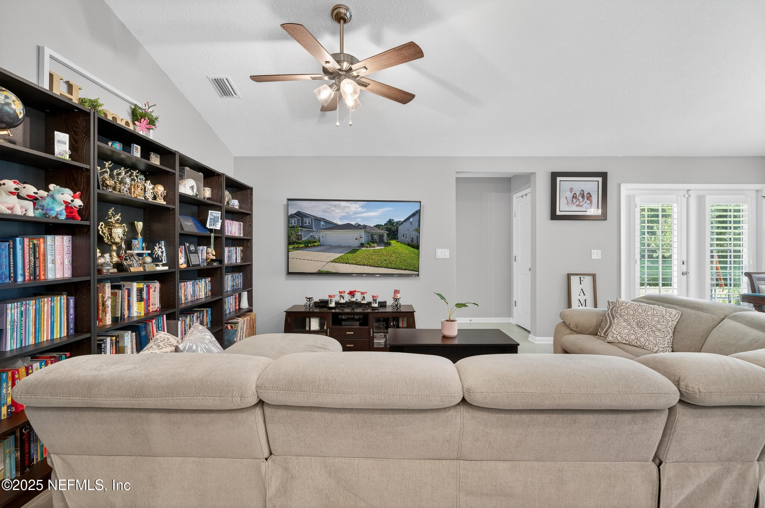 318 Rambling Brk Trail St. Johns, FL 32259 - Photo 9 of 26 a living room with furniture a book shelf and a window