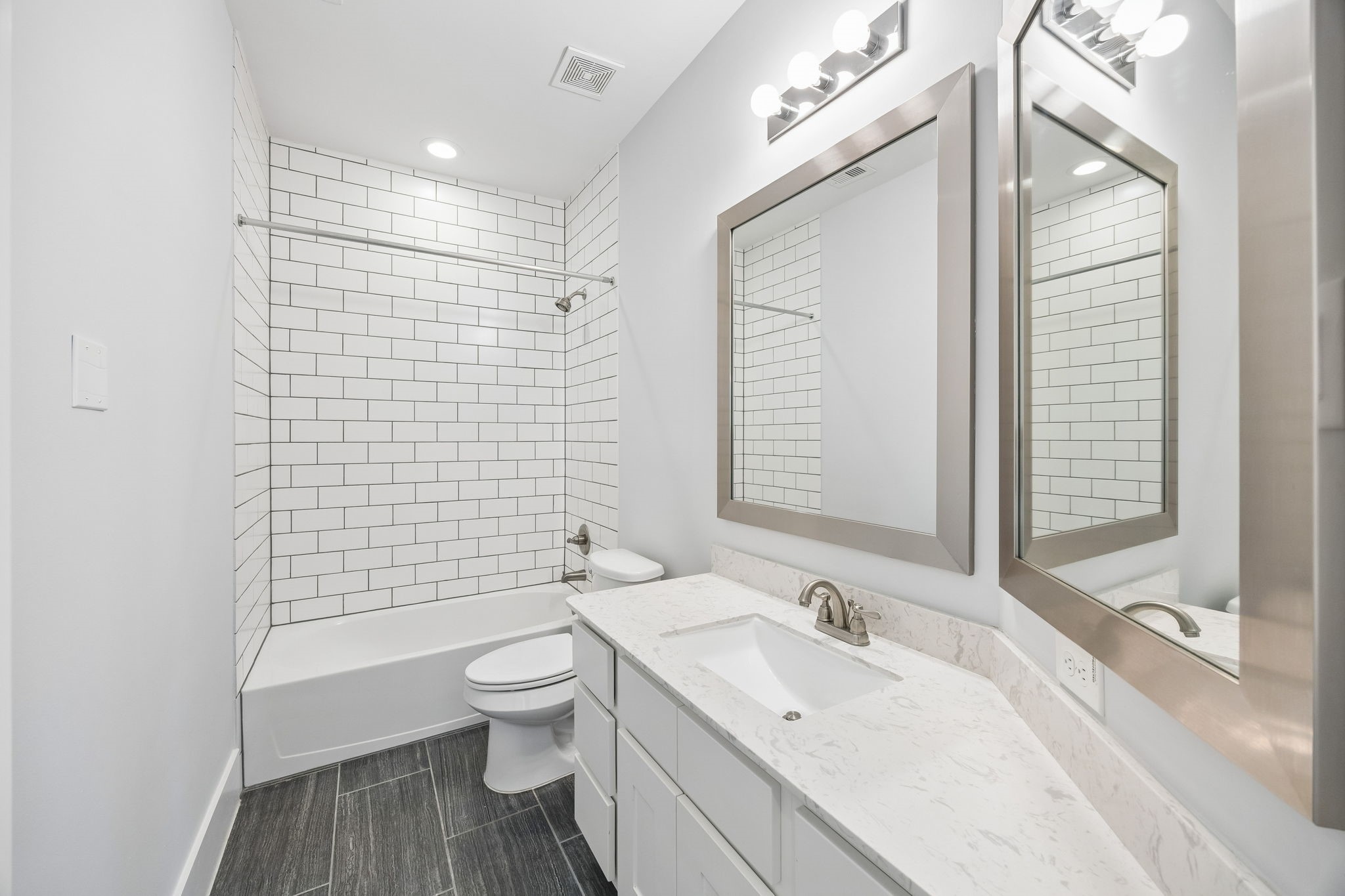 8558 Ridgepoint Drive Houston, TX 77055 - Photo 25 of 39 White cabinetry, broad mirrors, and light finishes give this bathroom a bright, cohesive appearance.