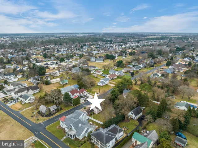 an aerial view of a swimming pool with outdoor seating