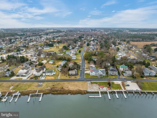 an aerial view of a swimming pool with outdoor seating